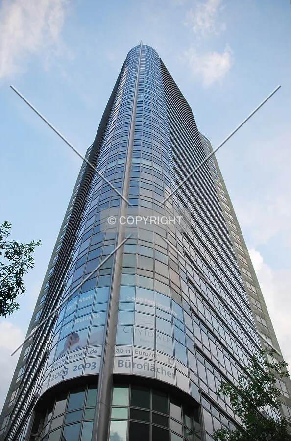 Tower rising against blue sky with clouds