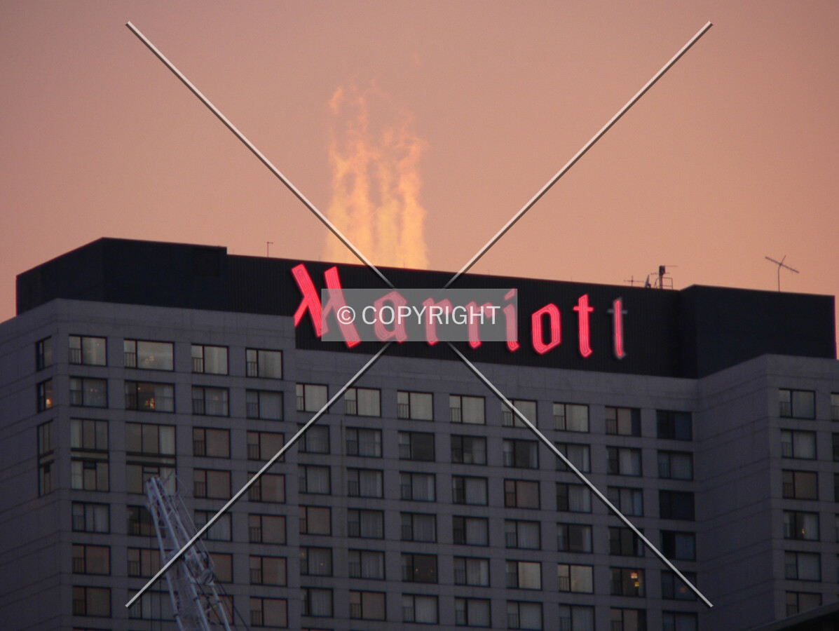 View to the northwest at dusk with ventilation steam backlit by the sun