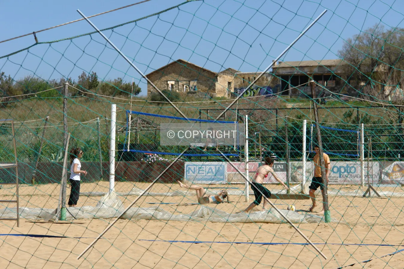 Young people playing beach volleyball