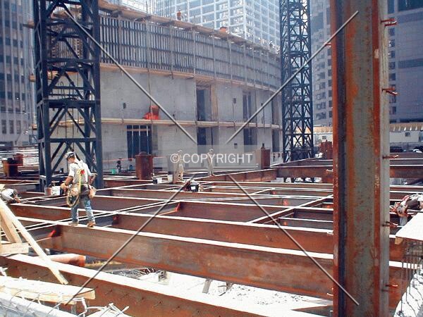 Ironworker gingerly making his way across the steel beams