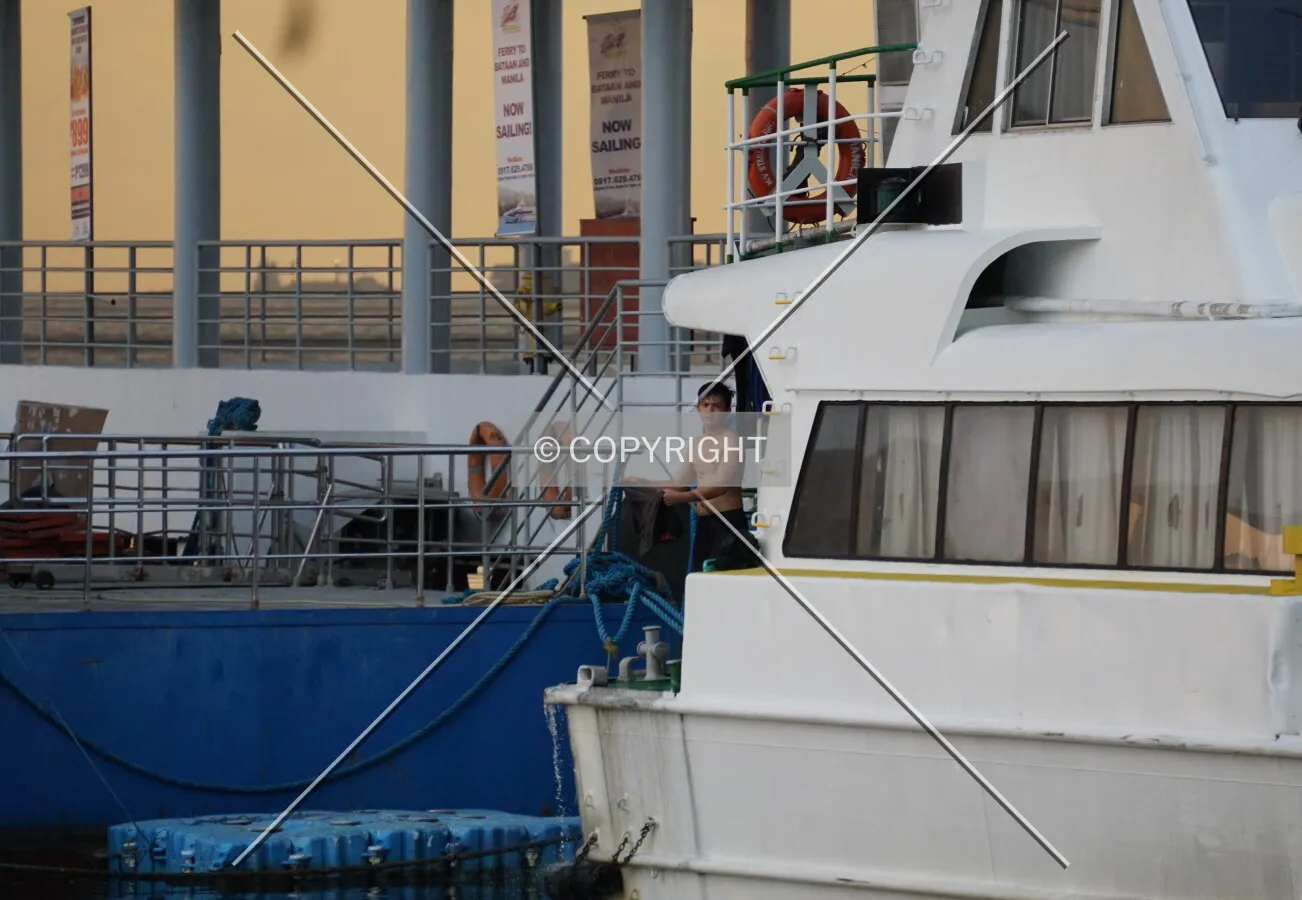 A man working on a boat docked at the terminal; February 26, 2018