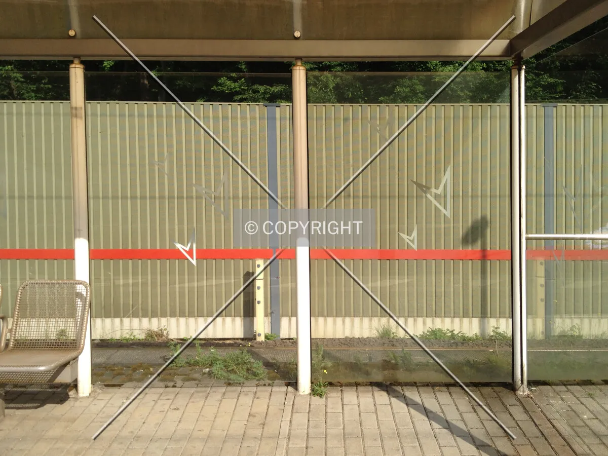 A waiting area in a glass shelter