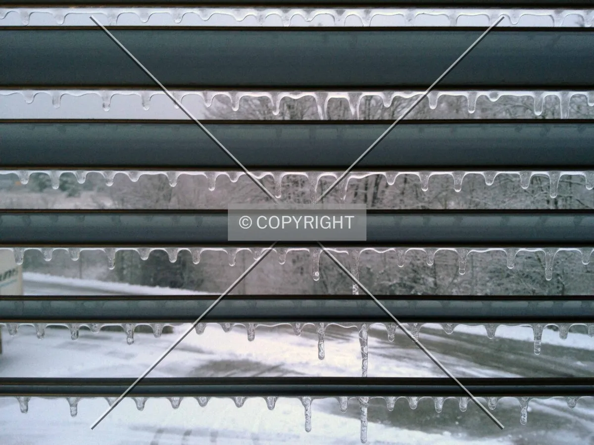 Icicled window shades in winter time