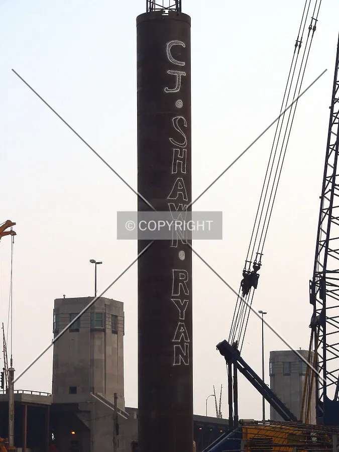 A caisson rock can ready for installation with the names of one of the construction workers kids painted in its side