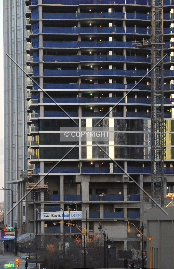 Western facade cladding on the lower floors, viewed from the CTA Roosevelt Road elevated station at dusk