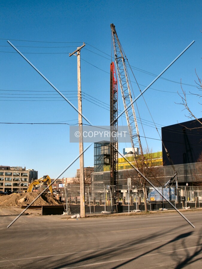 Pile driver shoring up the site, from 2nd Street South