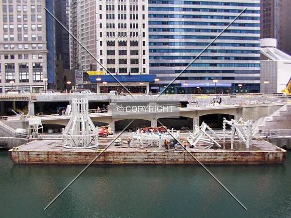 Barge in front of the tower holding the structural pieces