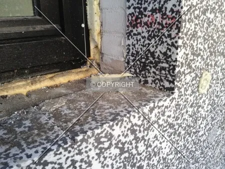 Insulation has been applied to a brick wall in order to save energy