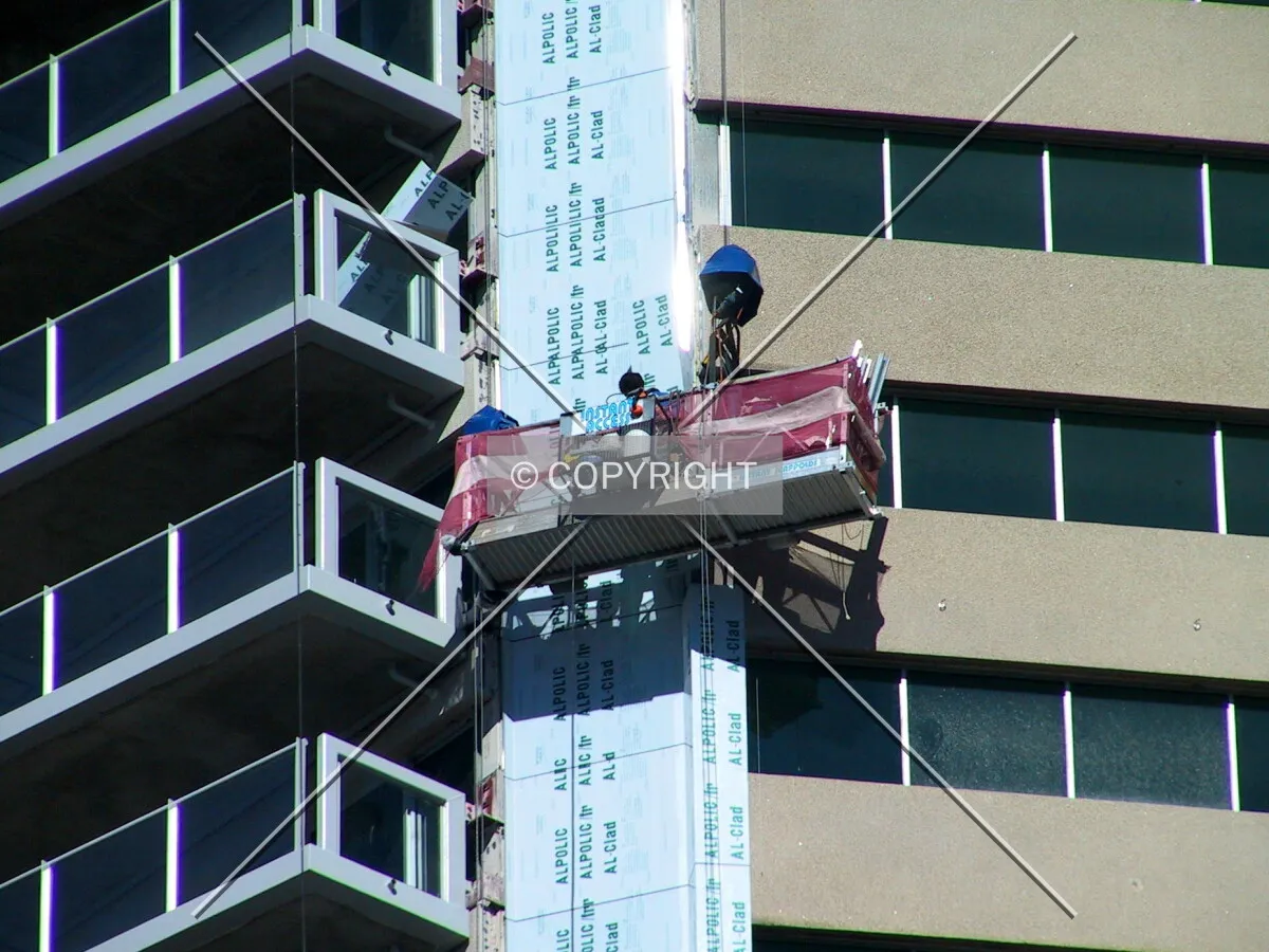 Workers applying cladding