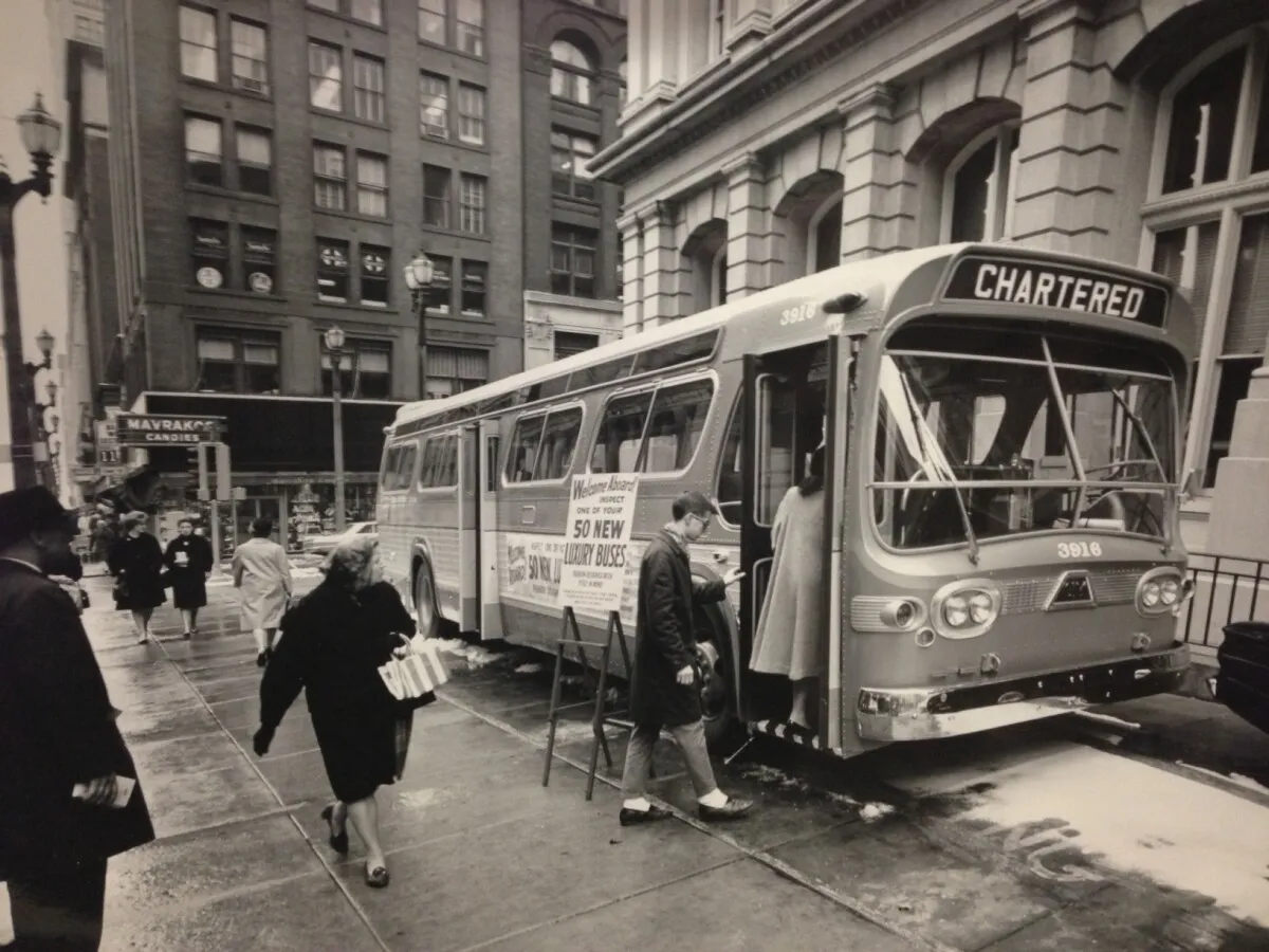 Vintage view of a bus outside of the Old Post Office; March 12, 1964