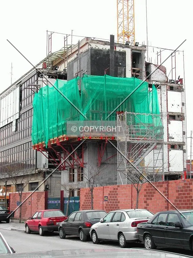 View of a core rising over the construction fence