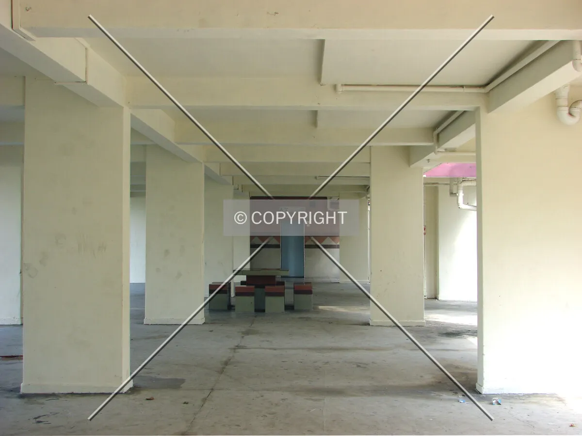 View of void deck area with seating and elevator