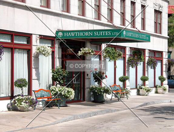 Vintage view of the main entrance on Jefferson Street showing the Hawthorn Suites sign