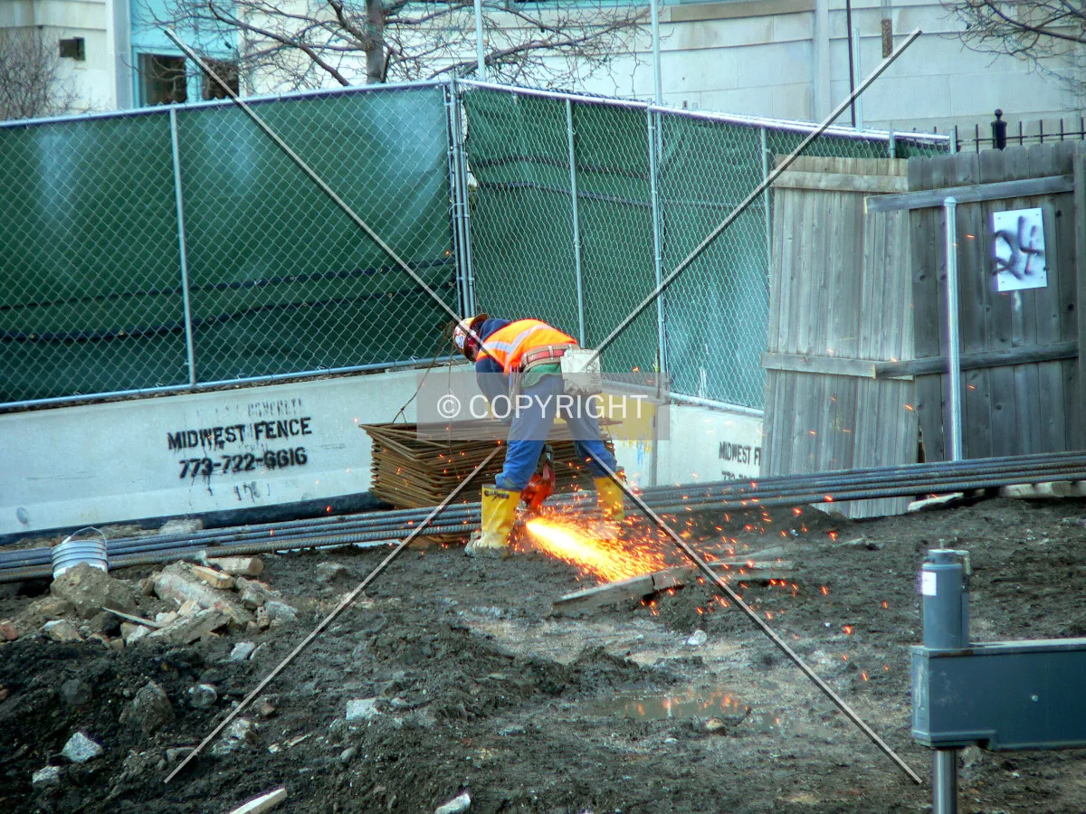 Worker cutting through rebar
