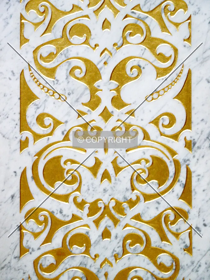 Detail of the marble and gold leaf on a pillar in the lobby