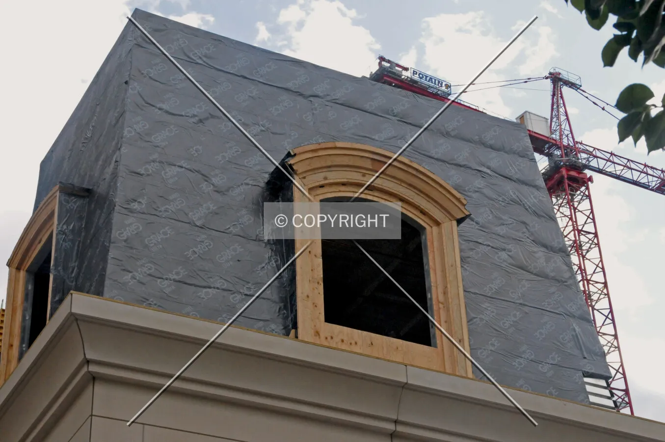 Mansard roof at the southeast corner of State and Walton Streets. The tower crane in the background is for the Walton on the Park development's South Tower