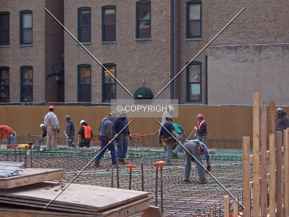 Workers tieing rebar for the ground level concrerte slab