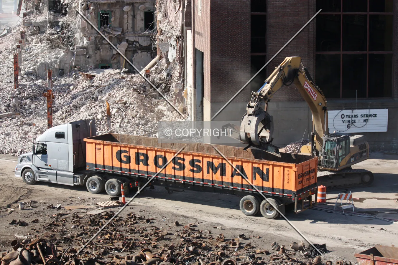 Building debris being loaded into a truck; August 11, 2011
