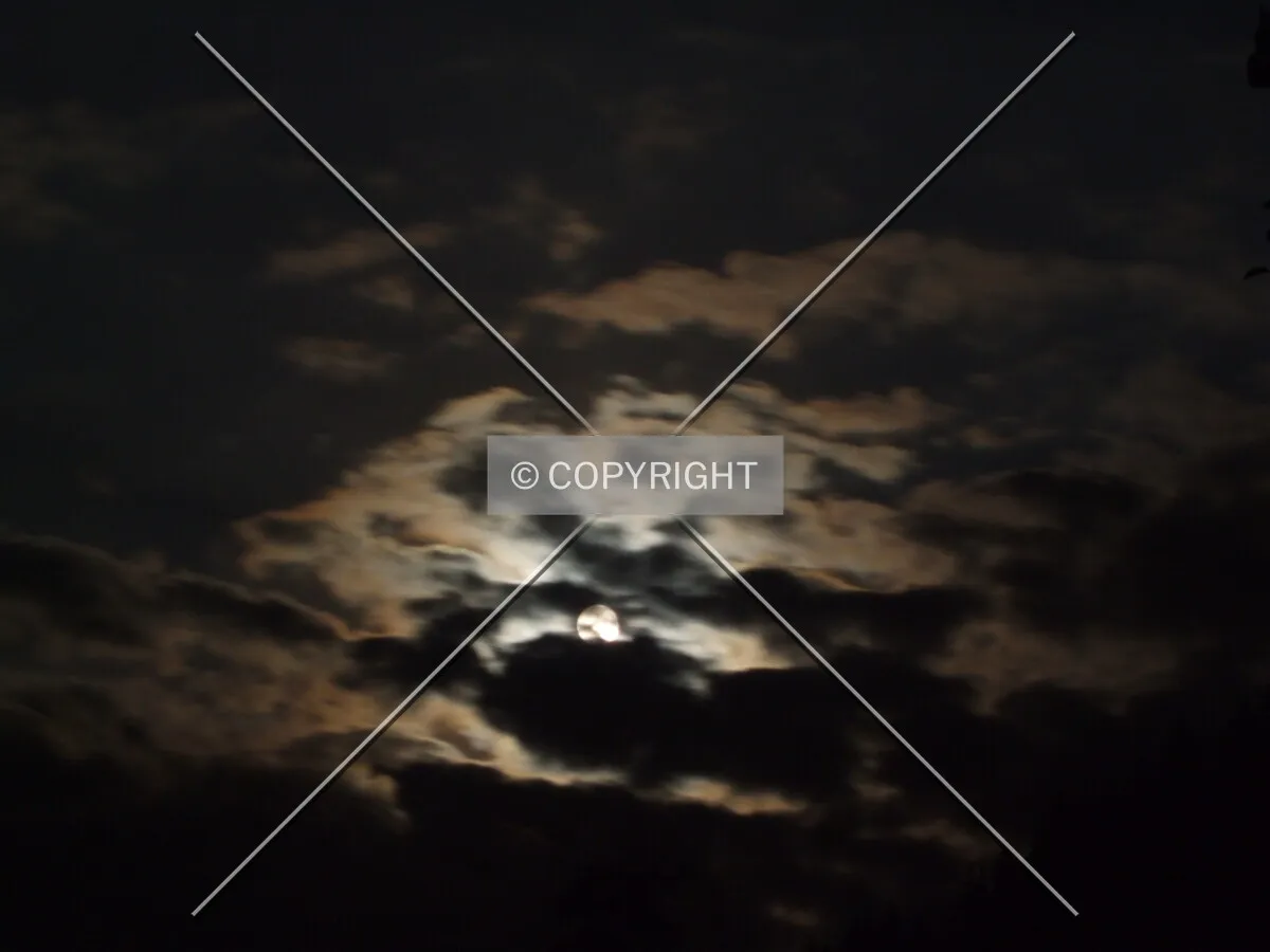 Full moon behind clouds.