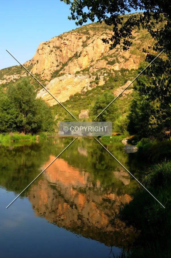 Segre River's mirror efect, reflecting mountain and trees