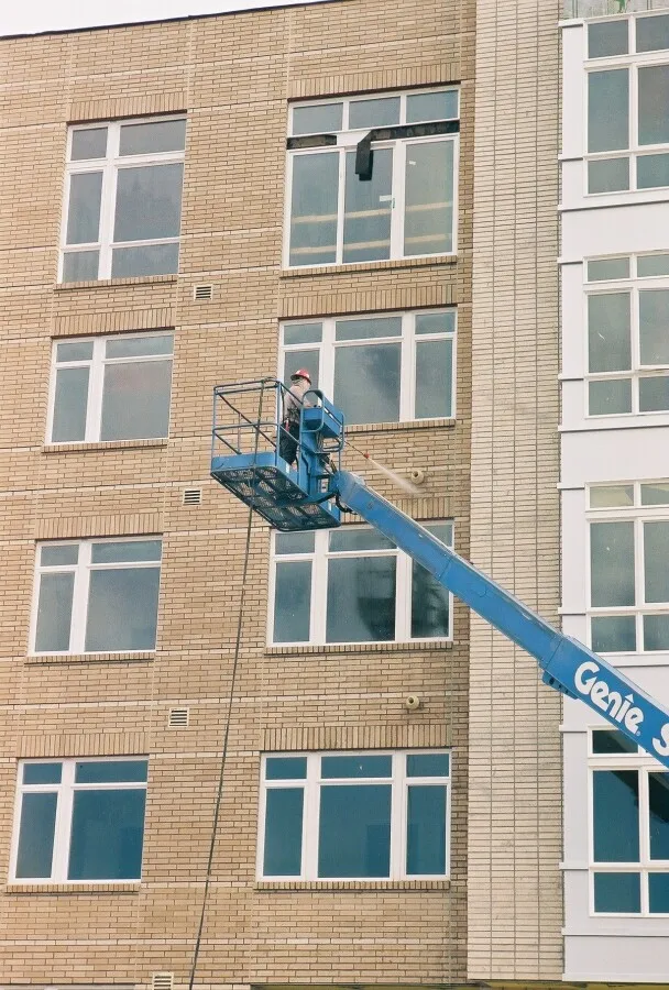 Power washing the new brick facade