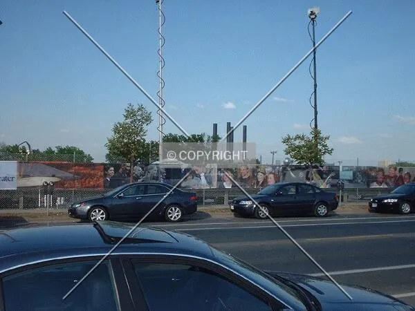 Survey of theater site with cars of groundbreaking ceremony attendees