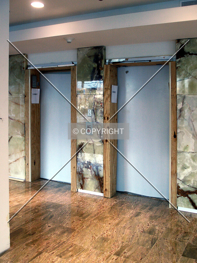 Elevator doors in the lobby with temporary wood framing
