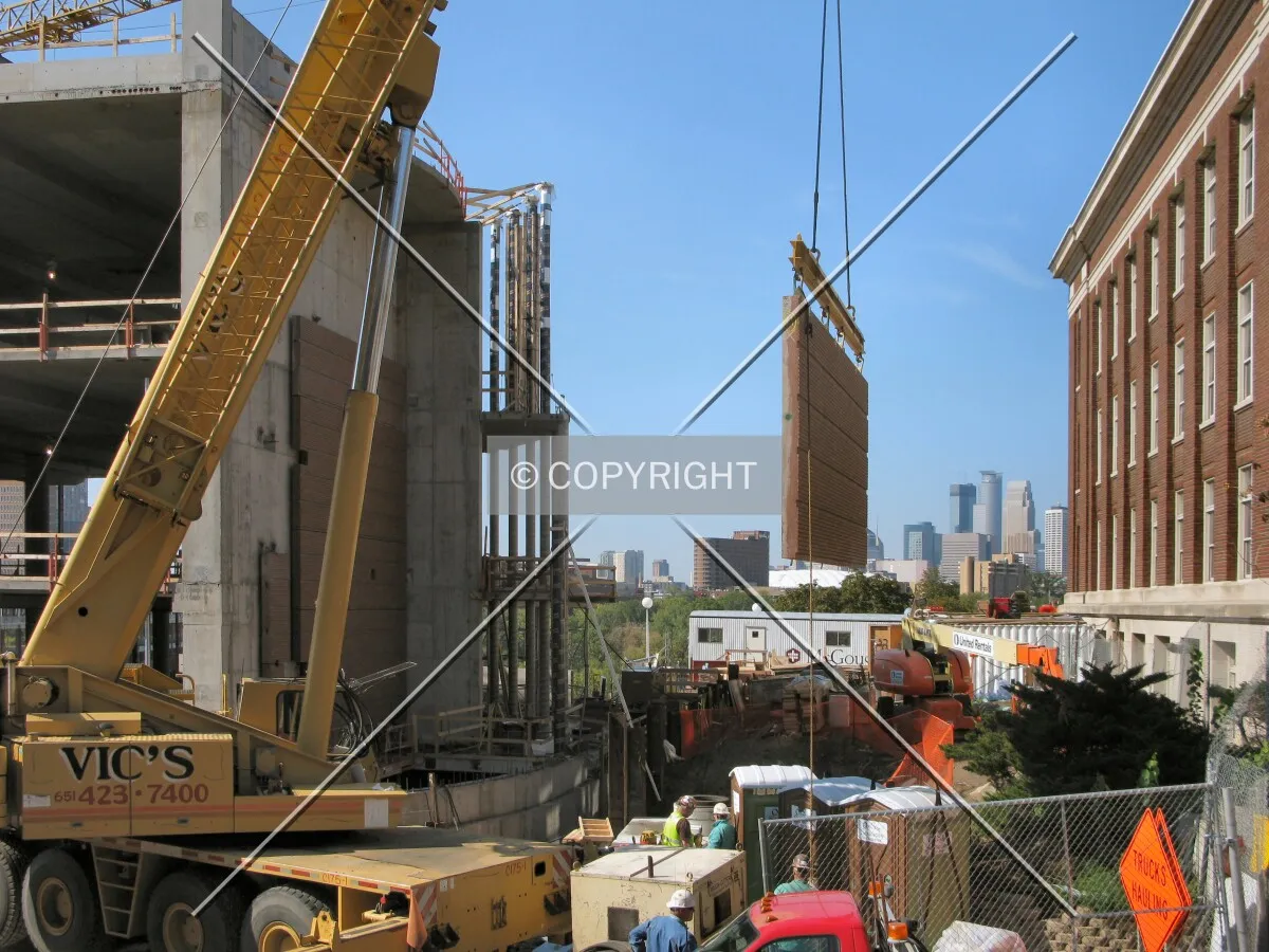 Lifting a section of facade into place; downtown in distance