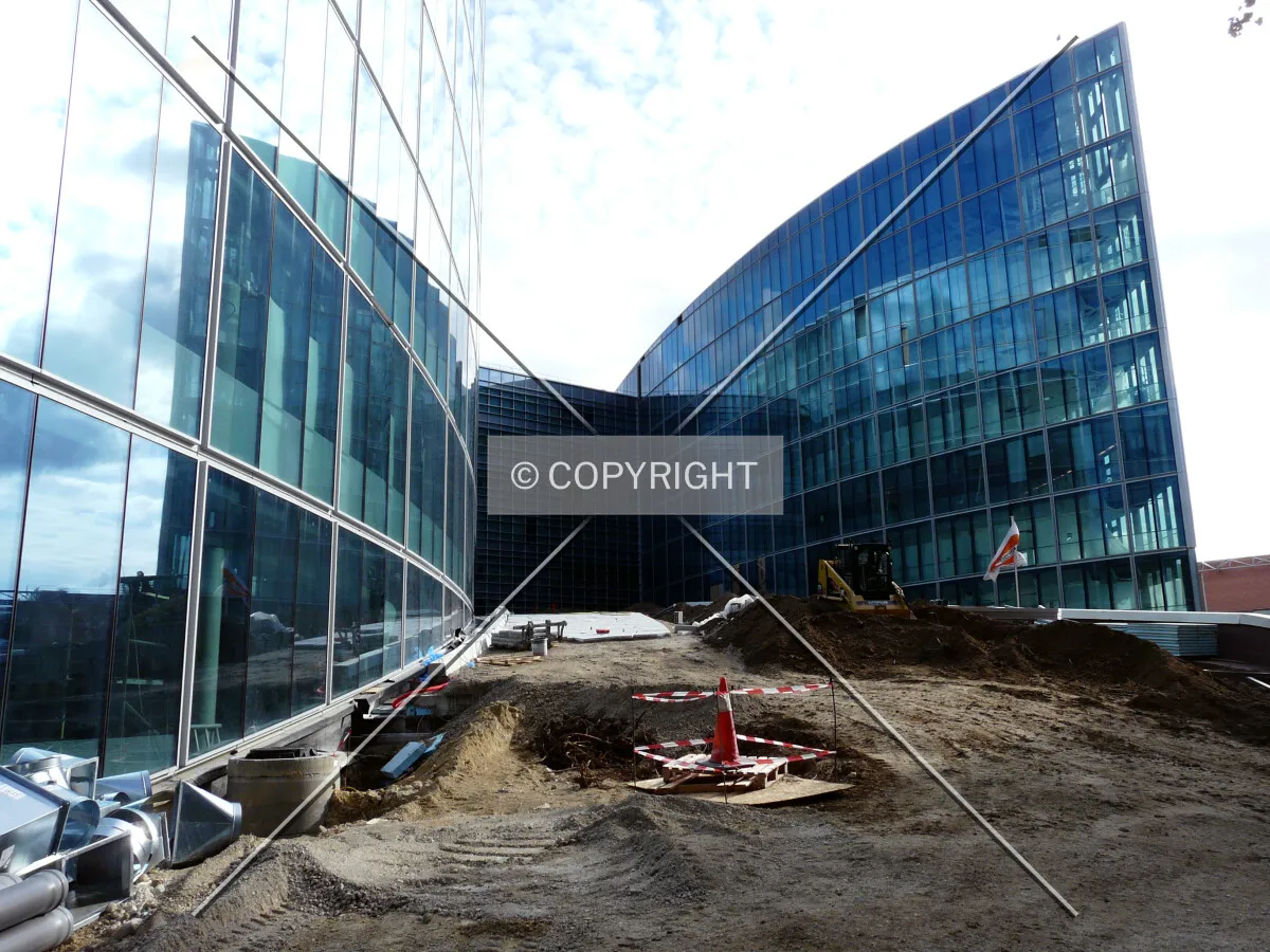 View of the sloped fire trucks access under construction between the central and west wings