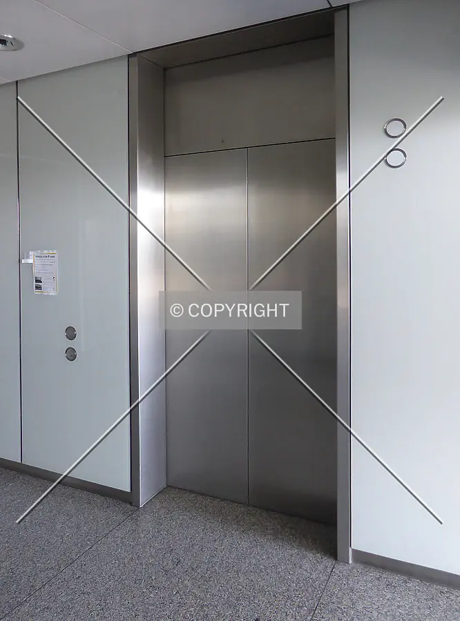 In front of one of the building's panoramic elevators