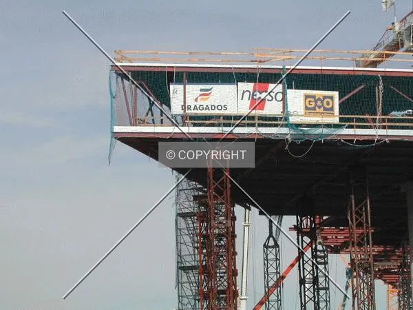 View of one corner of the building with flags of the different construction companies