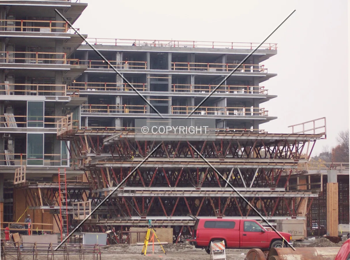 Stacked scaffolding platforms and the first panes of glass on the Oak Tower