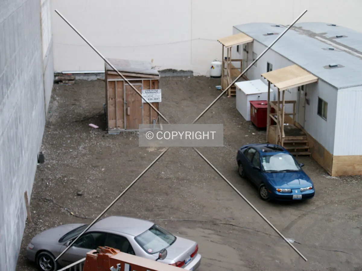 Field office and construction crew parking area west of the podium