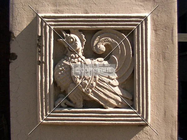 Stone carving on the gate between the buildings