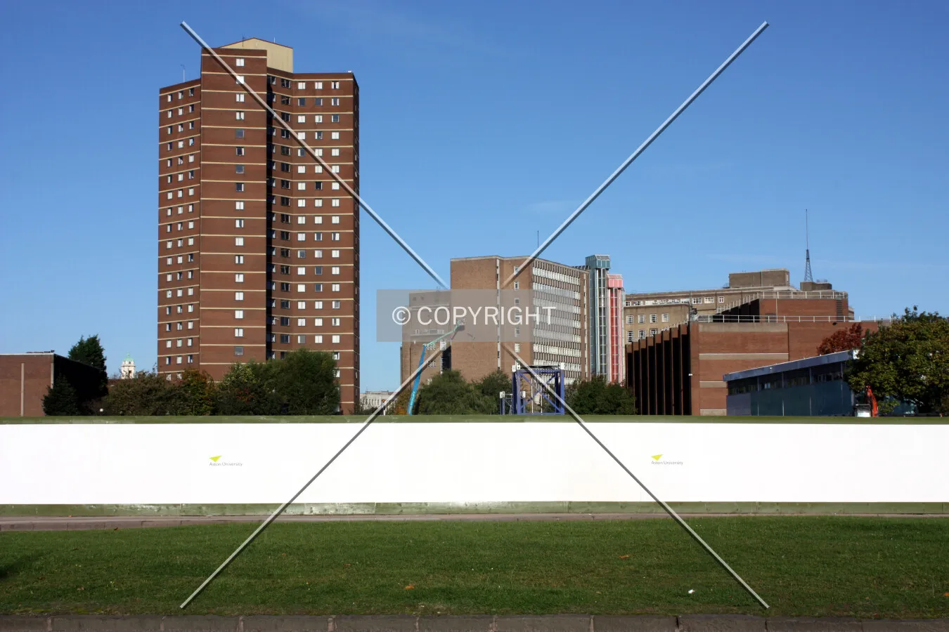 Base of the crane visible above the site boundary