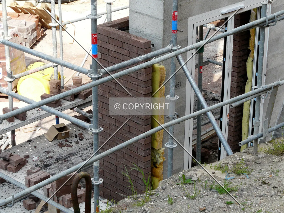 Brick-cladding test on a cinder block wall