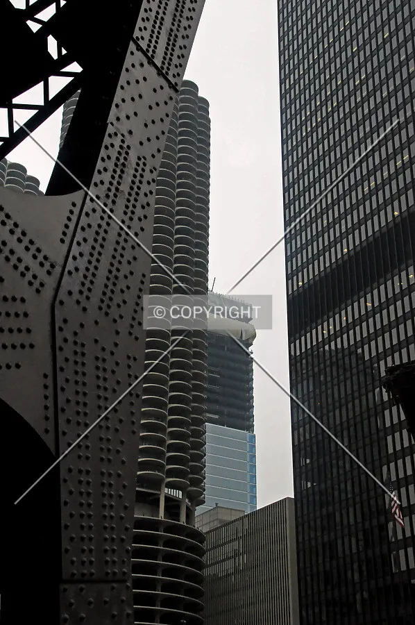 Contextual view looking northwest between IBM Plaza and Marina City from Wabash Avenue. The Wabash Avenue bridge has been drawn for riverwalk construction and is in the upright position on the left