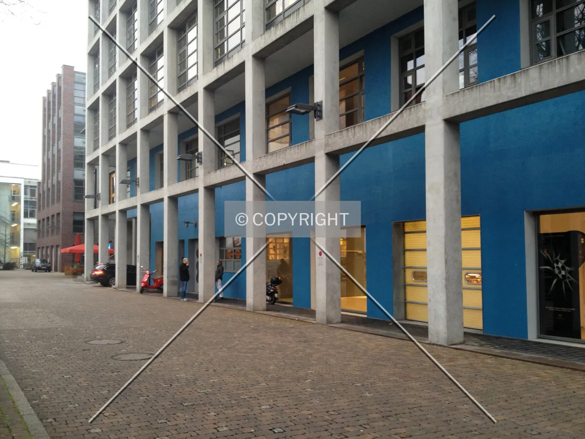 The sheltered sidewalk and concrete columns