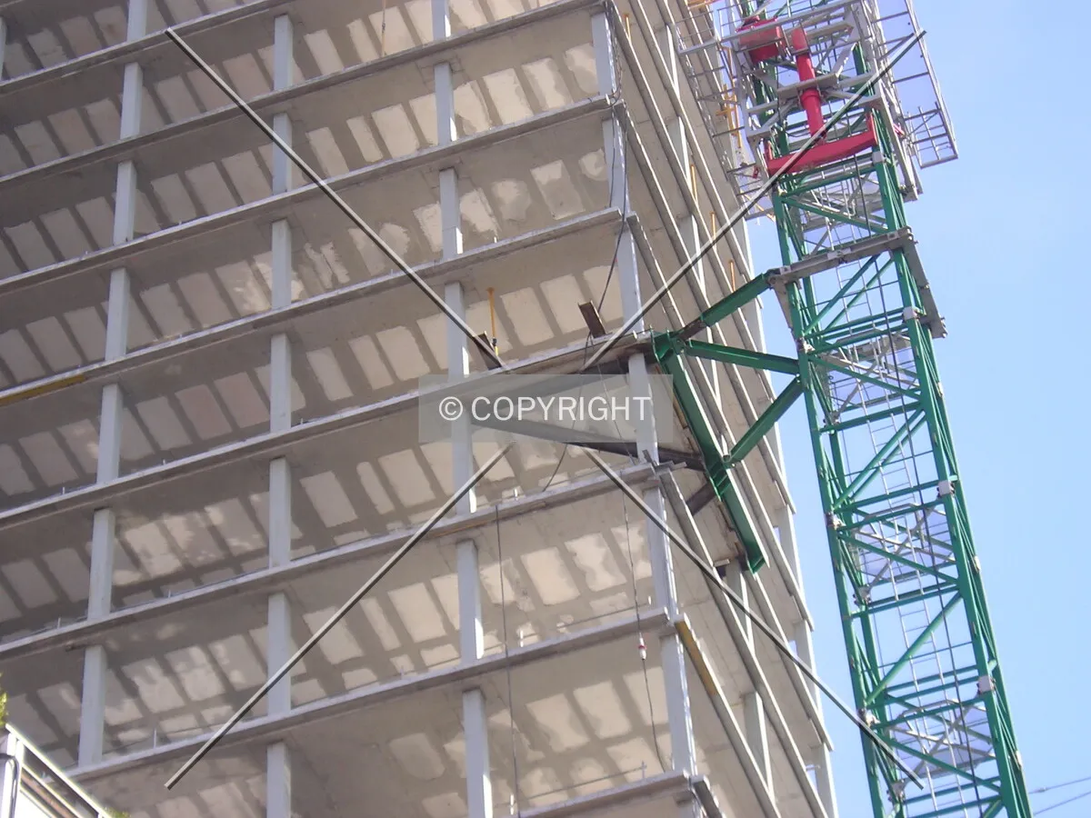 View of the junction of the construction crane with the building at the 11th floor