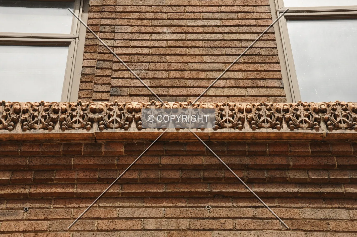 Terra cotta belt course at second floor