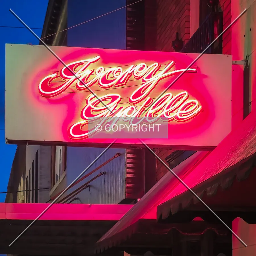 Ivory Grille sign on the west facade; March 29, 2025