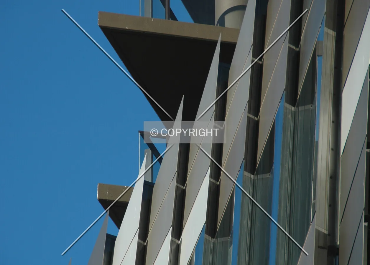 Detail of the slanting podium facade with the tower balconies above