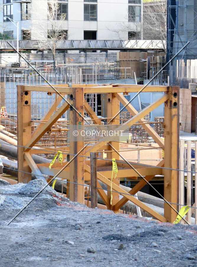 Tower crane base visible along the eastern edge of the site