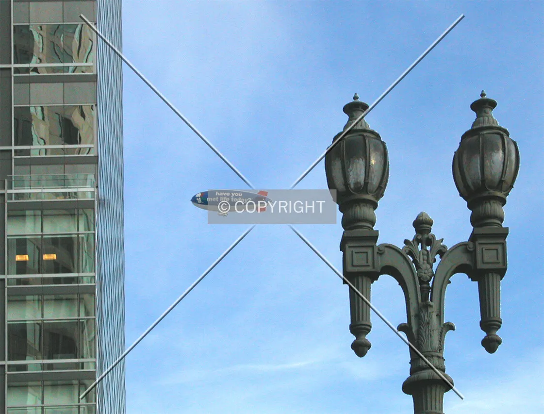 Downtown lamp post, tower and blimp