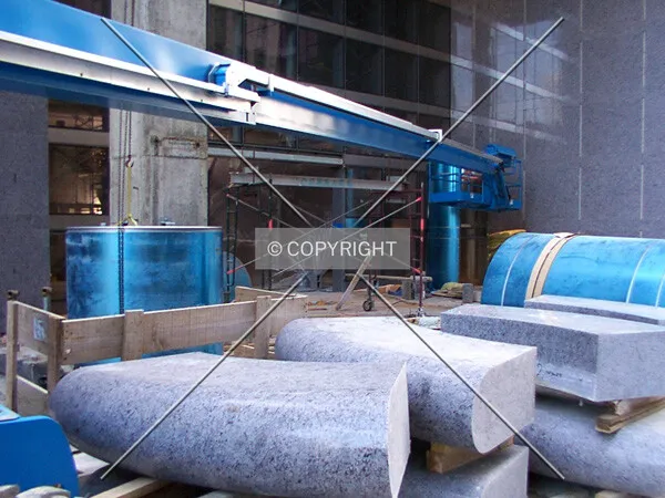 Residual construction: column covers and bench segments at the northwest corner