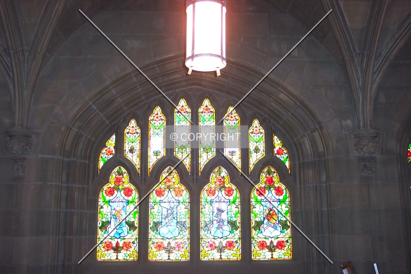 The stained glass window above the central door at the main entrance, view from inside