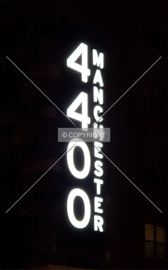Sign on the east facade at night; July 19, 2018