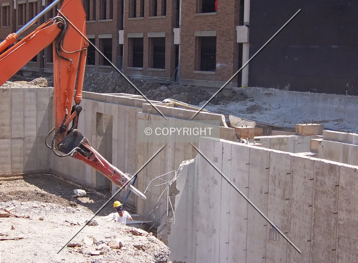 Breaking up a foundation wall in the southwest corner of the site