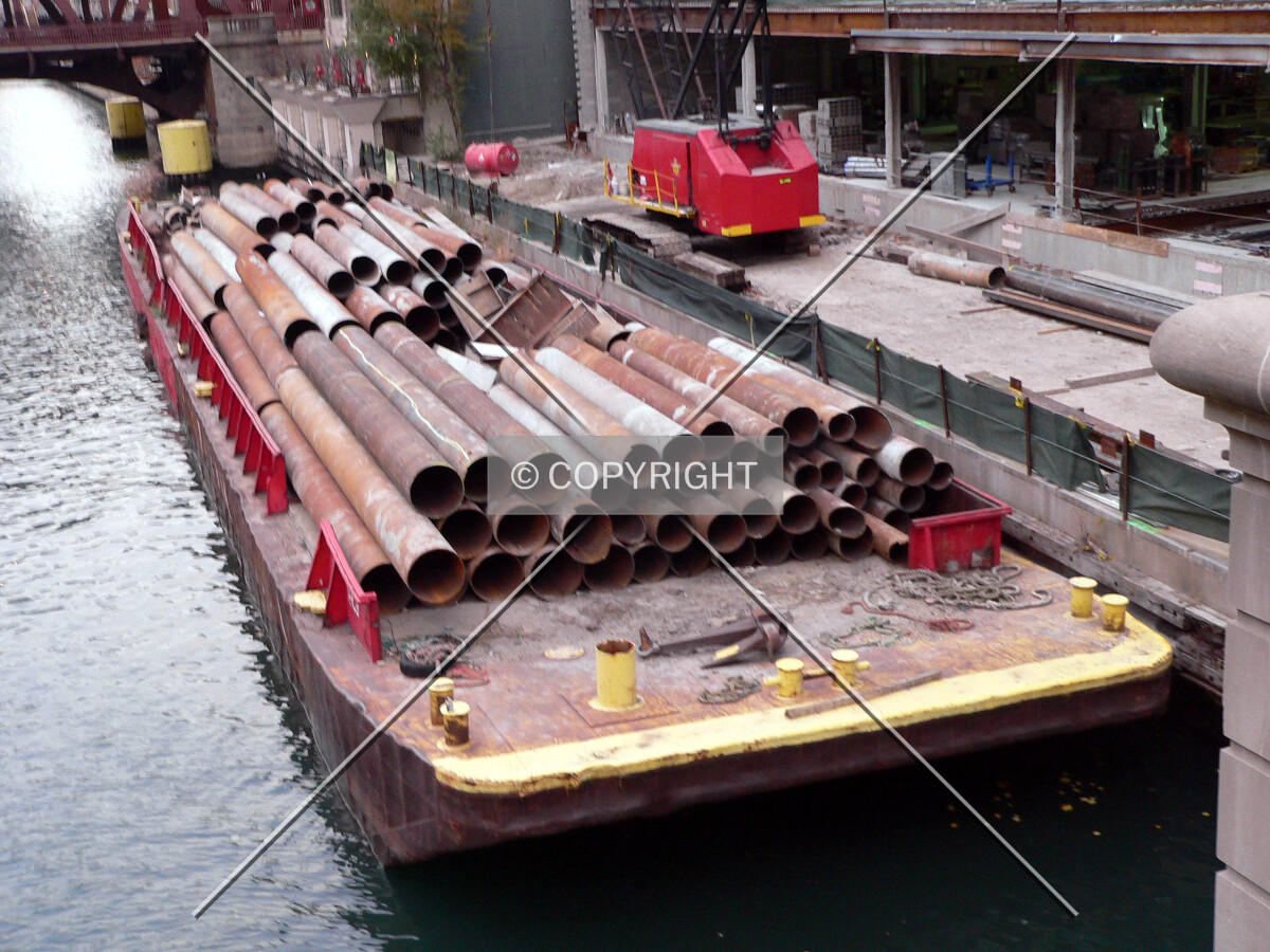 Cut raker beams on a barge alongside the project