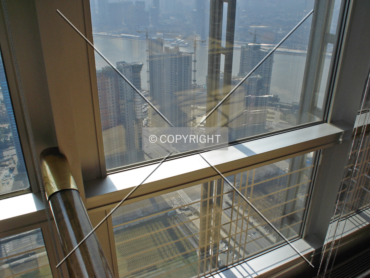 Part of the facade and looking through the window over Shanghai